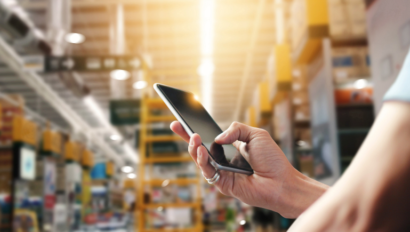 woman texting in a hardware store