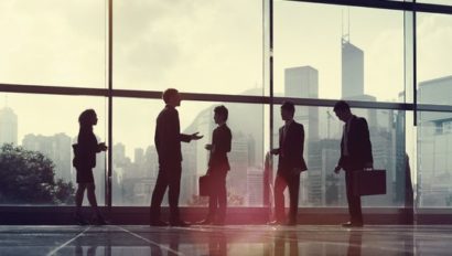 5 people standing in front of a window at an office