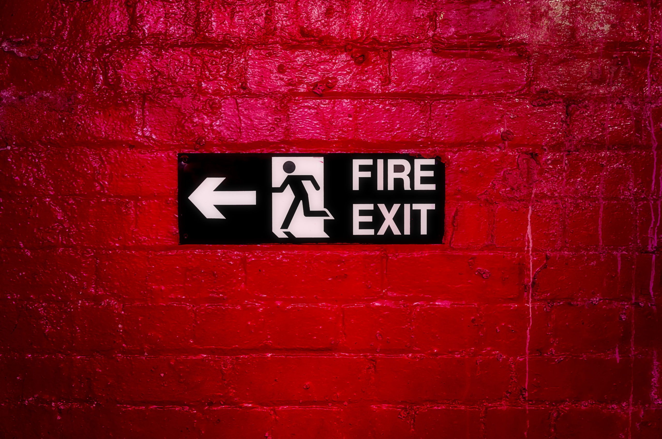 Fire exit sign on a brick wall