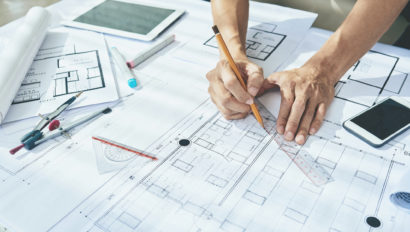 architect drawing on blueprint