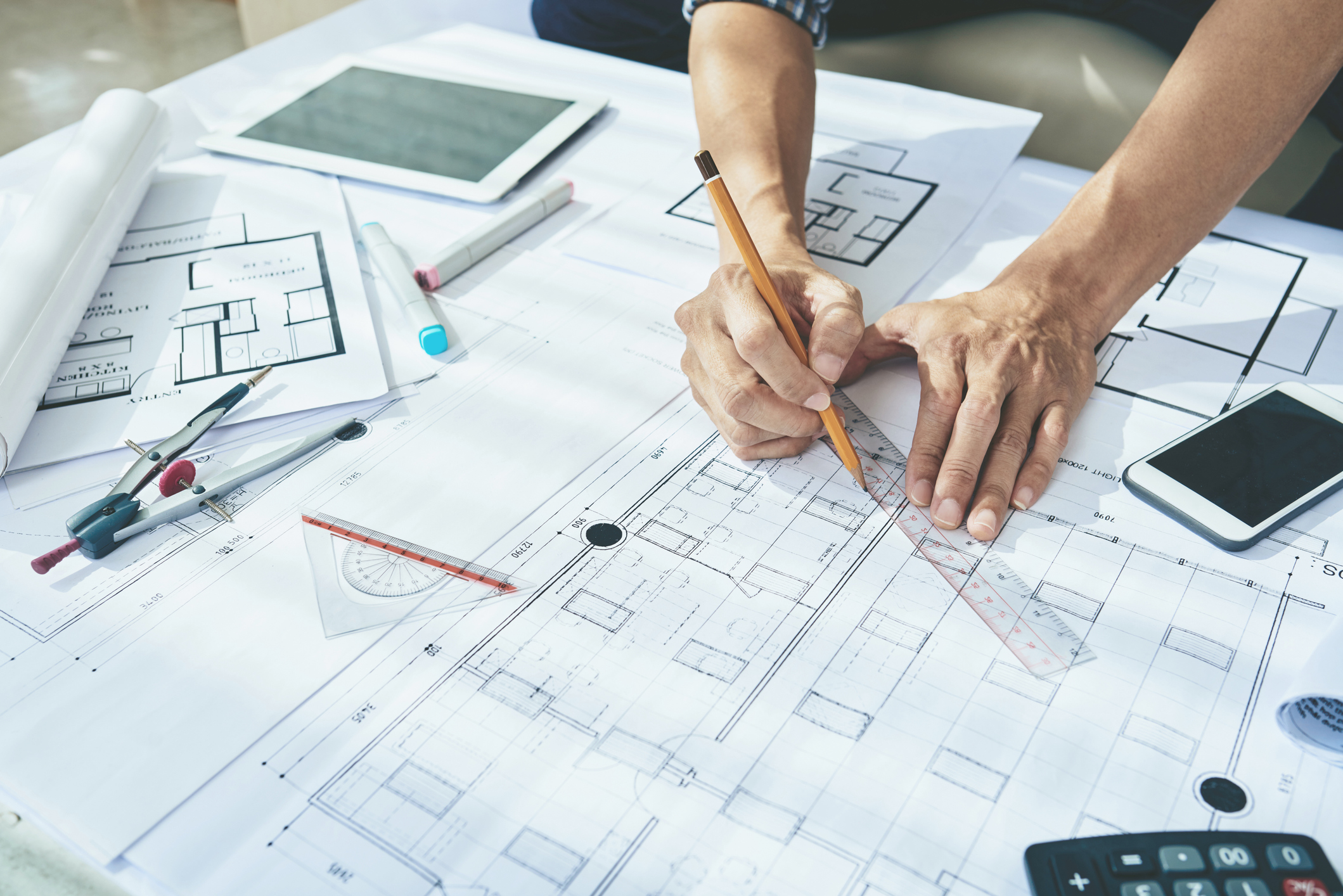 architect drawing on blueprint