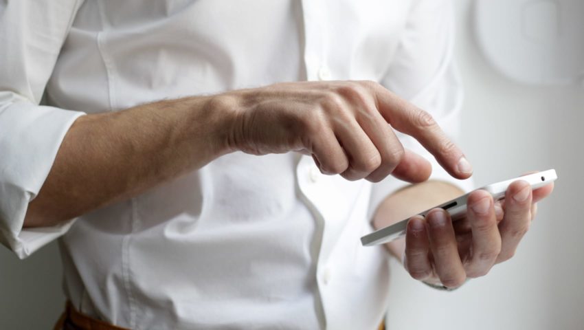 Adult man touching a cellphone