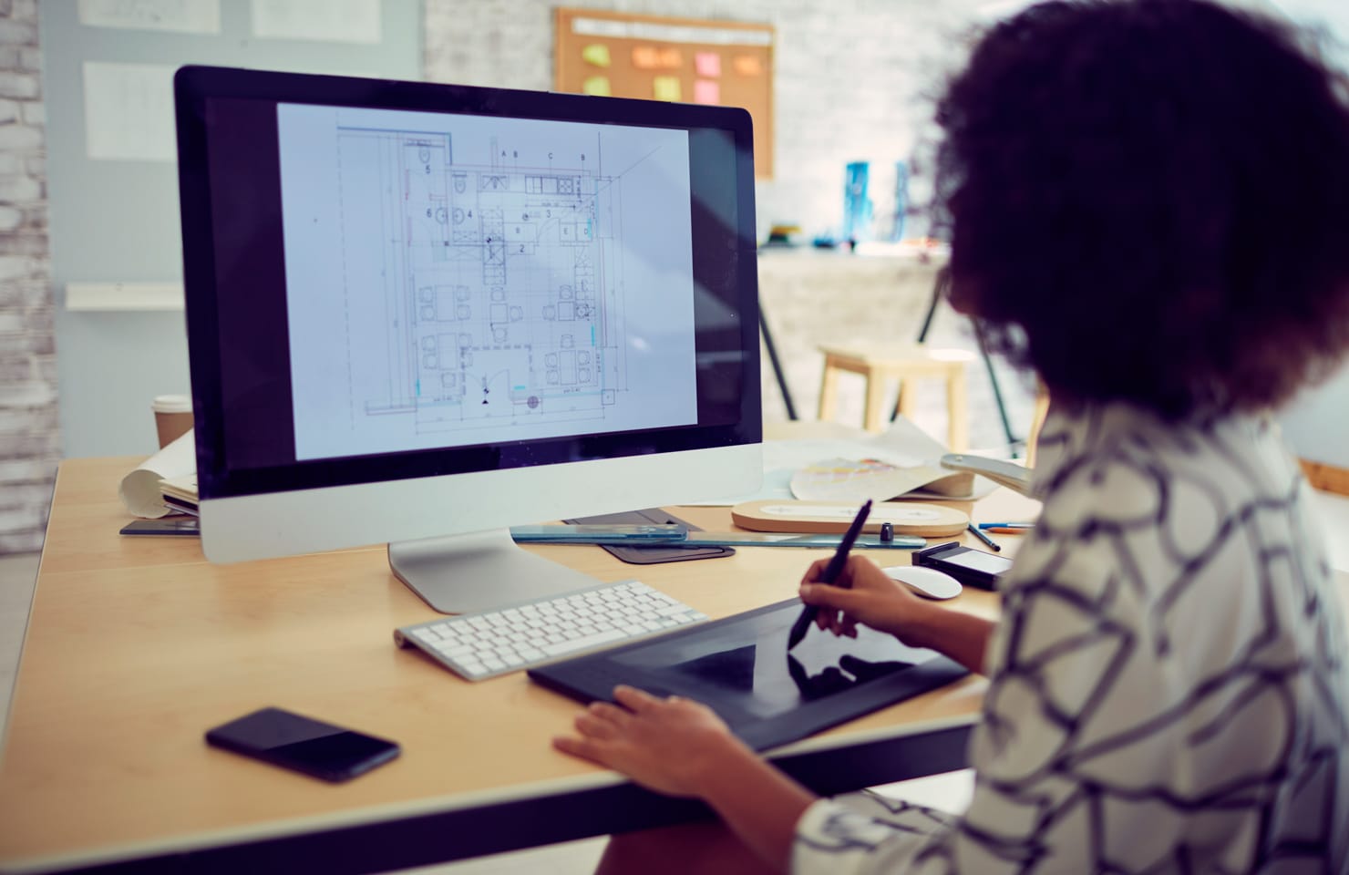 Woman looking at floor plans on a computer