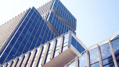 Looking up towards a glass building