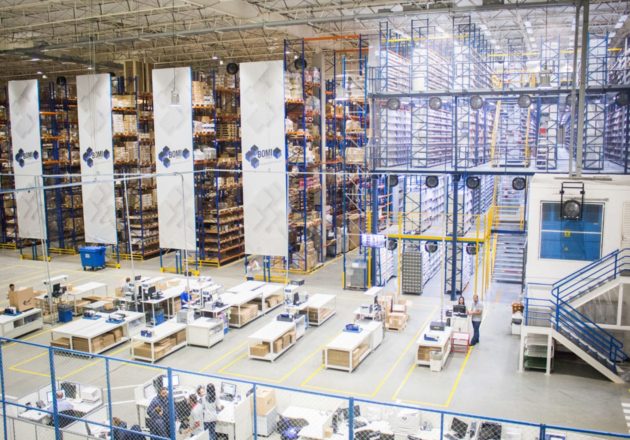 Interior of a warehouse with workers at desks