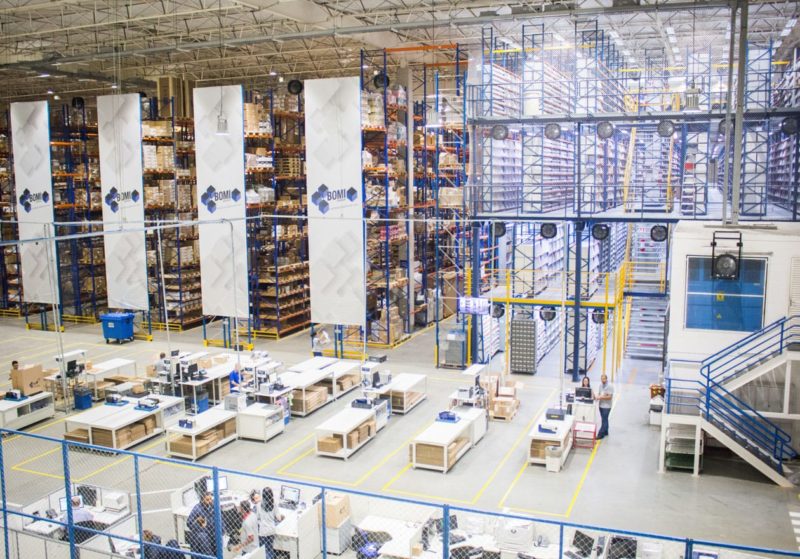 Interior of a warehouse with workers at desks