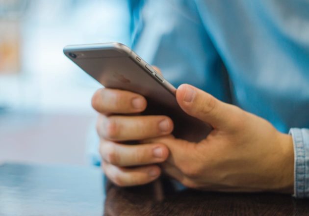 Person reaching out to ongoing support on their phone