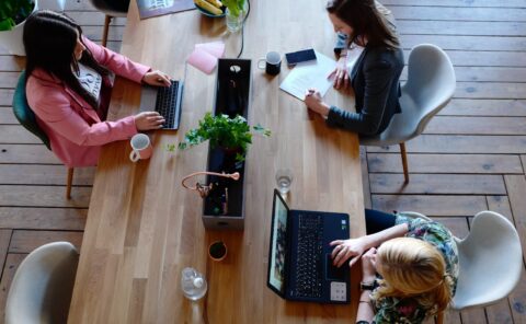 Three people working in a WeWork space
