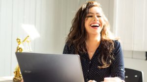 Woman on her computer laughing