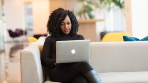 Woman sitting on couch at computer