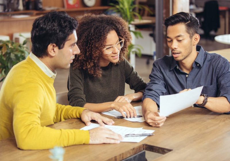 Three diverse staff talking
