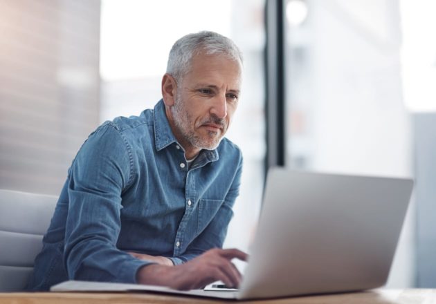 Older male executive working on a computer