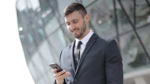 Male Property Manager standing by office on his phone