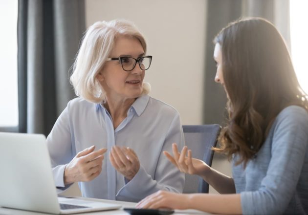 Older female property manager speaking to a woman