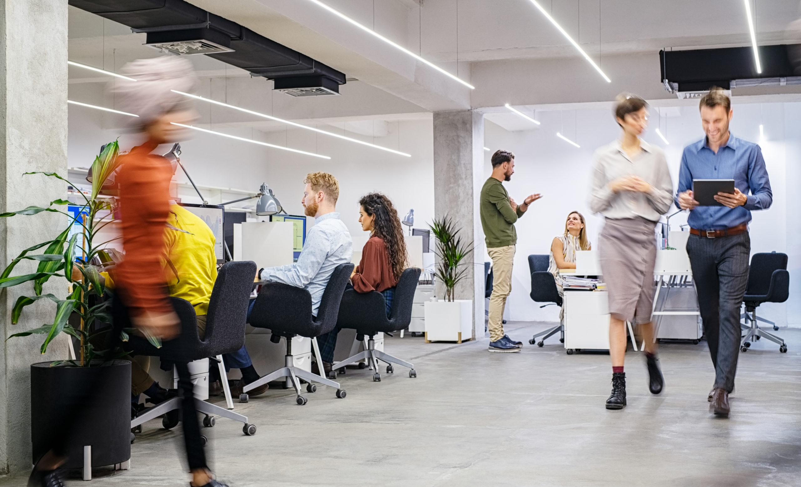 Business people walking in a commercial office.