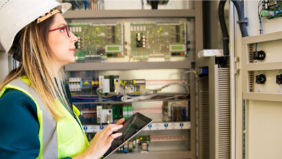 A worker inspects wiring