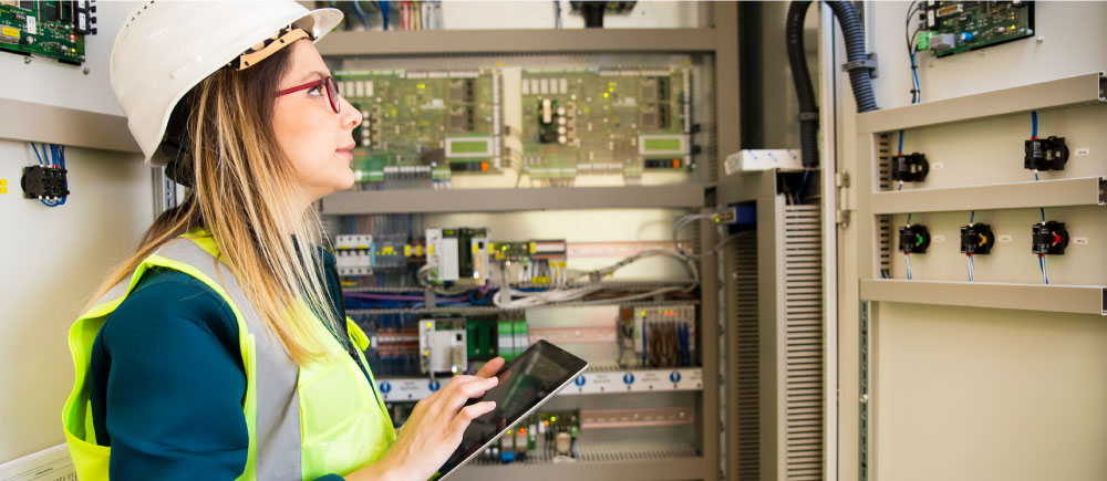 A worker inspects wiring