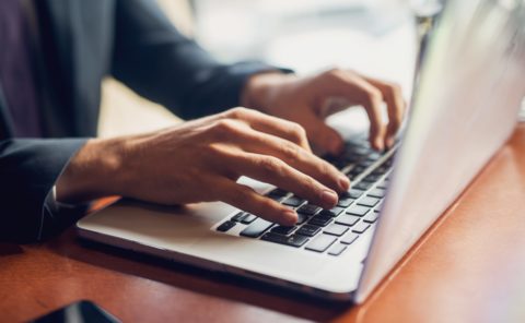 Person typing on computer
