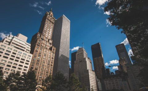Looking up towards NYC buildings
