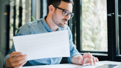 Man examining a vendor selection and holding paper