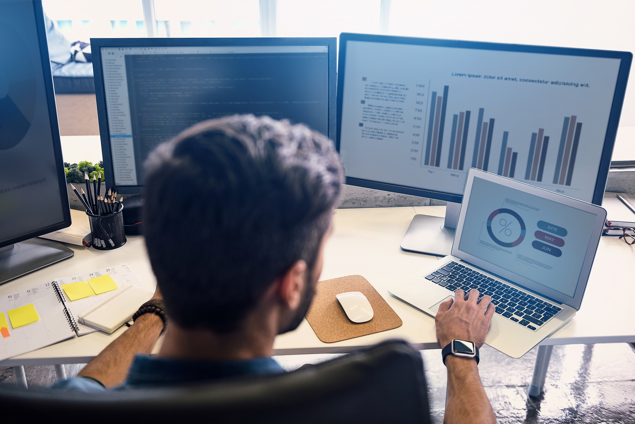 Business professional working at desk with the help of commercial real estate technology