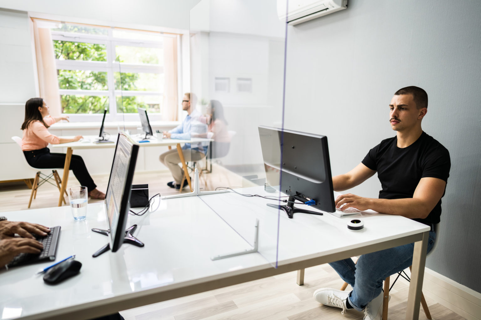 Employees sitting, going back to work after covid 
