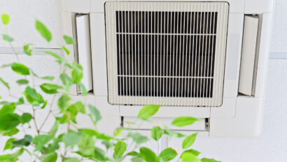 Ceiling air conditioner in modern office or at home with green leaves