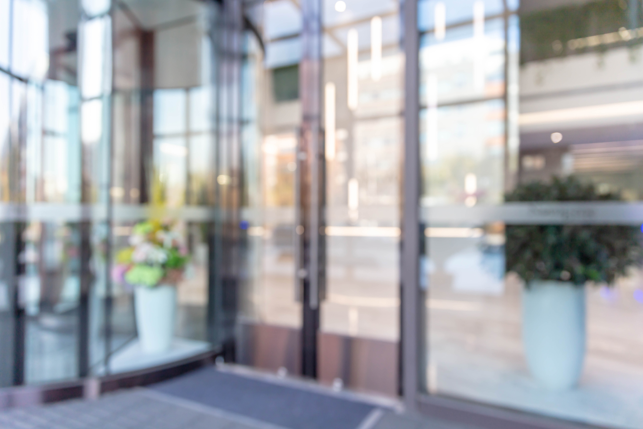Defocused background effect of revolving doors at the entrance of a building