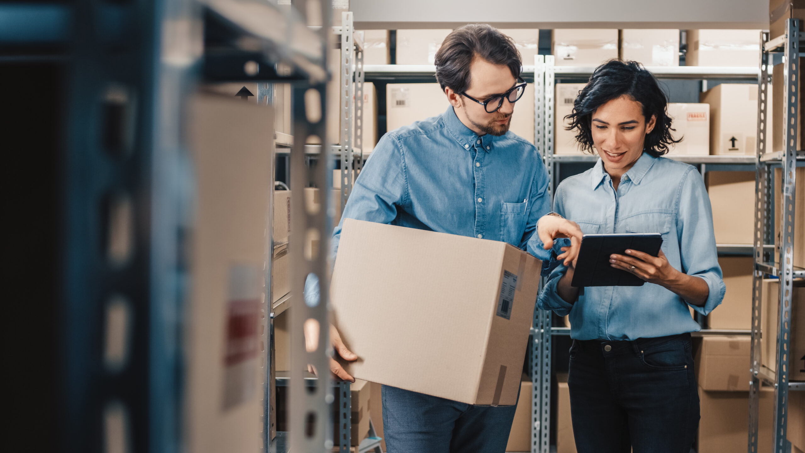 two young professionals in an office looking at a tablet. Proptech case studies