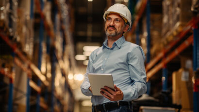Man working in a warehouse via digital tablet