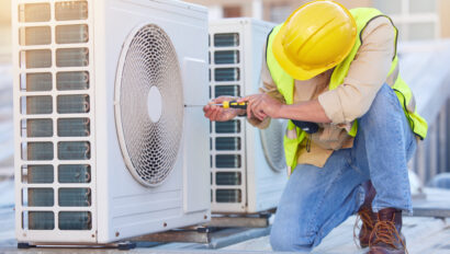 Air conditioning, technician or engineer on roof for maintenance, building or construction of fan hvac repair. Air conditioner, handyman or worker with tools working on a city development project job