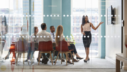 Woman presenting in an office. Property management trends.