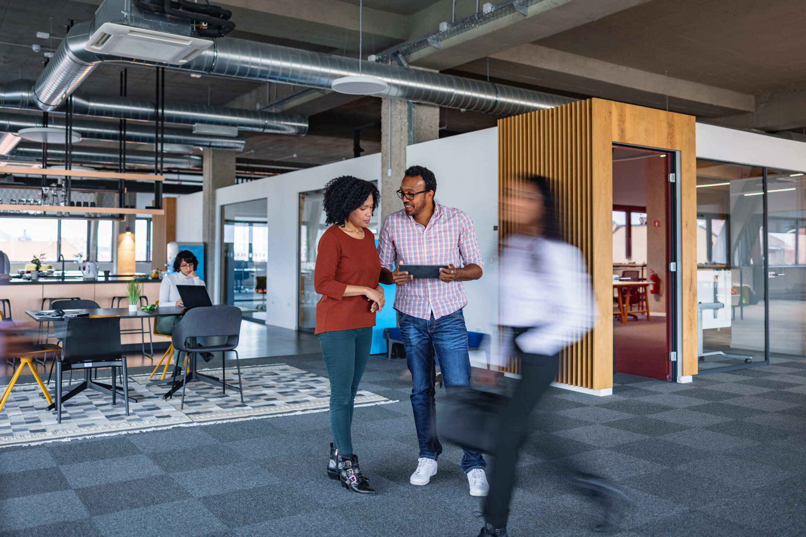 Hispanic Business Colleagues Talking In The Office