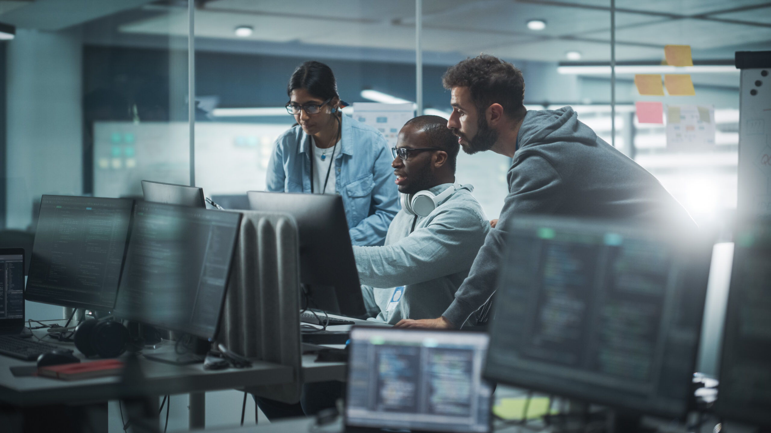 3 people working at a computer