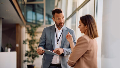 Business colleagues communicating while working on digital tablet in the office.